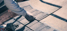 service 1 close up shot of worker installing new asphalt roof shingles