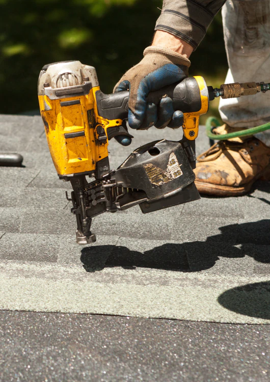 close up shot of worker doing asphalt roof replacement